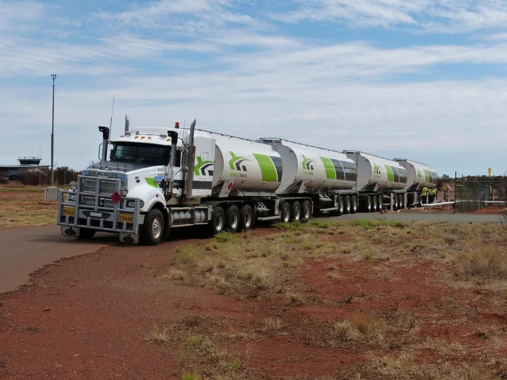 A large road train fuel tanker transporting multiple trailers