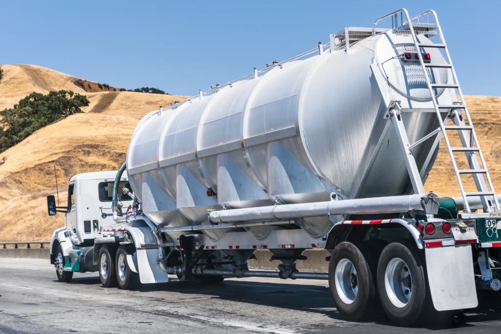 tanker-truck-driving-on-the-freeway-2024-12-05-17-08-38-utc - Rhino Fuel Fuel delivery tanker truck driving on a highway, showing how fuel delivery works in transporting fuel to different locations