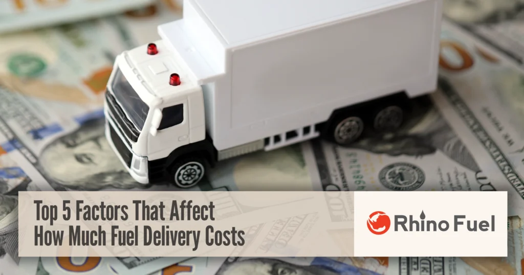 Toy fuel delivery truck on U.S. dollar bills illustrating how much does fuel delivery cost and the factors that impact pricing.