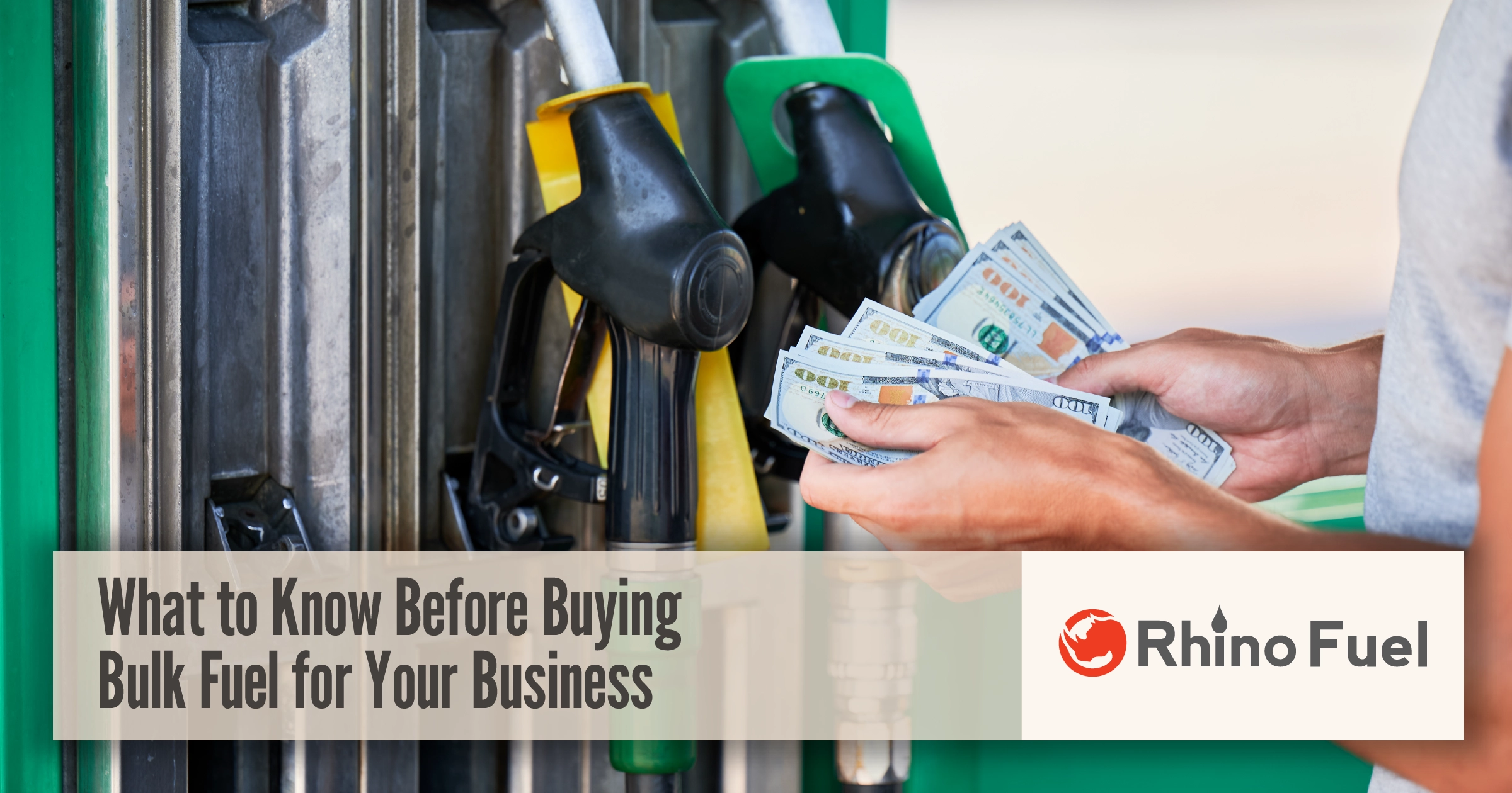 Person holding cash at a fuel pump illustrating bulk fuel purchasing considerations and costs for businesses.