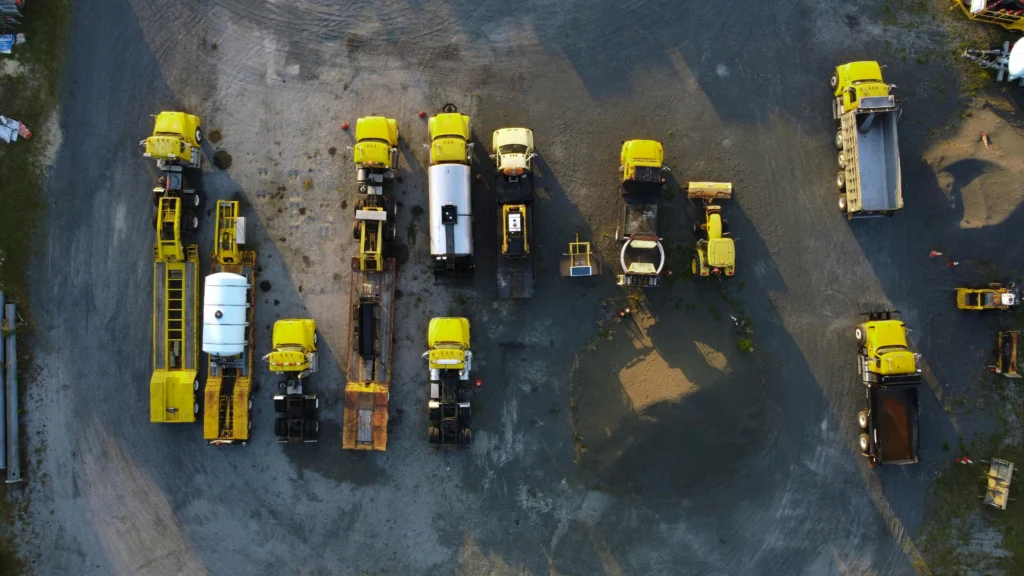 Aerial view of yellow fuel delivery trucks showing the benefits of premium gas