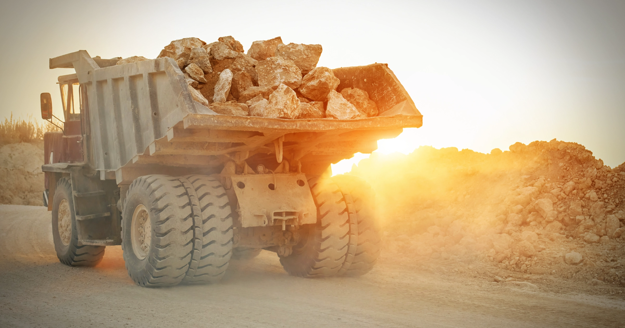 RF-Blog-FeatureImage-RF Is Construction Site Fuel Delivery More Cost Effective Than Fuel Cards2x - Rhino Fuel Construction site fuel delivery for heavy equipment with dump truck transporting materials on an active job site