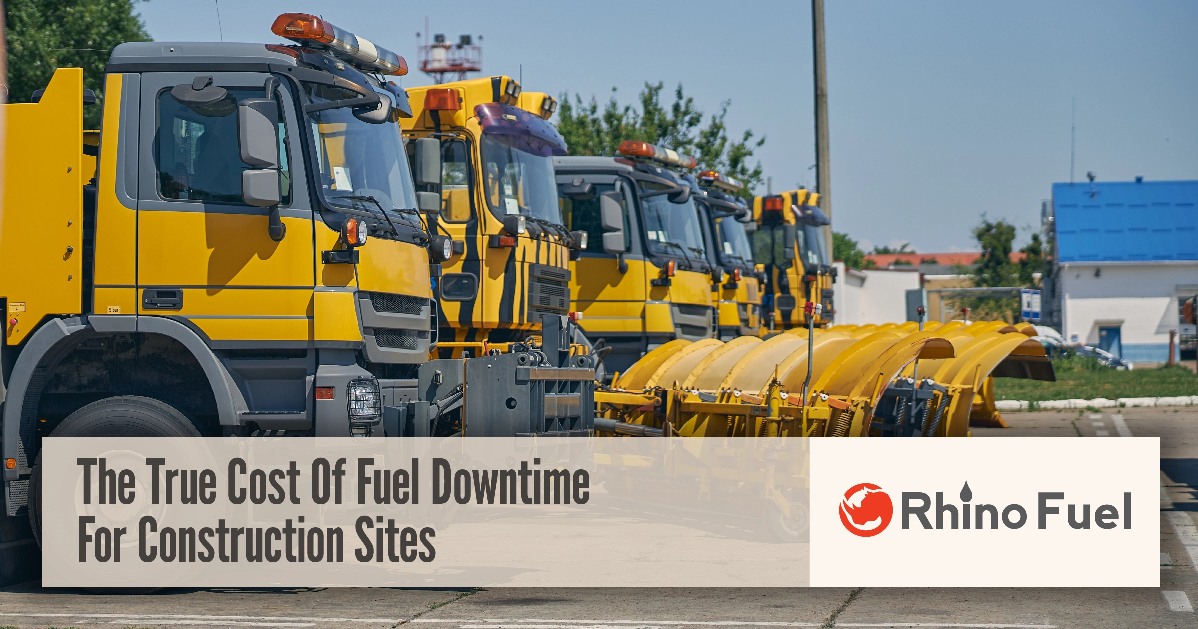 Construction trucks lined up on a job site, highlighting fuel downtime cost and its impact on construction site productivity and operations