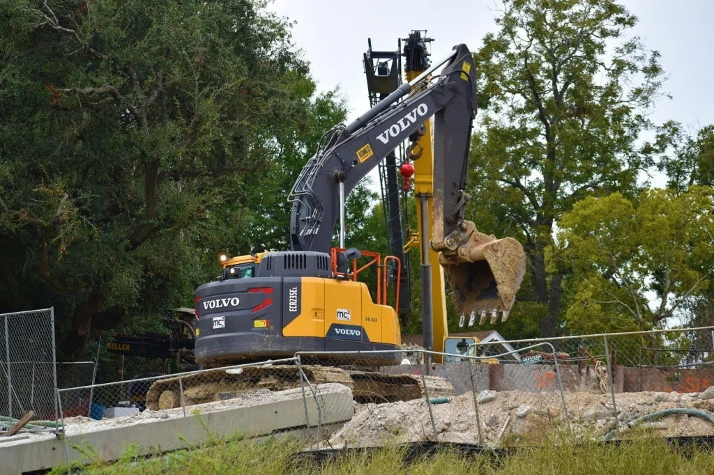 Construction site fuel delivery supporting excavator equipment on an active job site with heavy machinery in operation