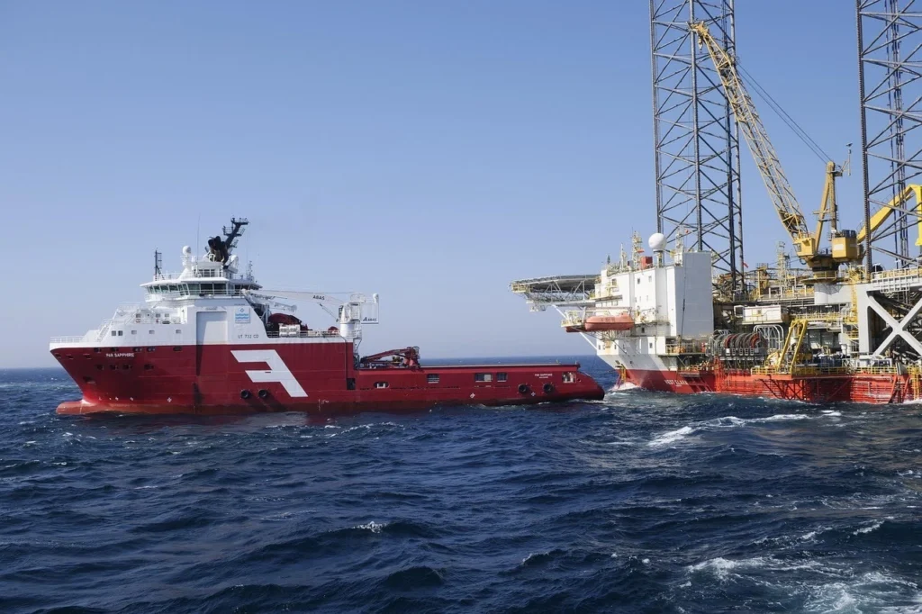 Fuel supply chain offshore vessel transporting fuel near oil platform as part of global fuel distribution operations