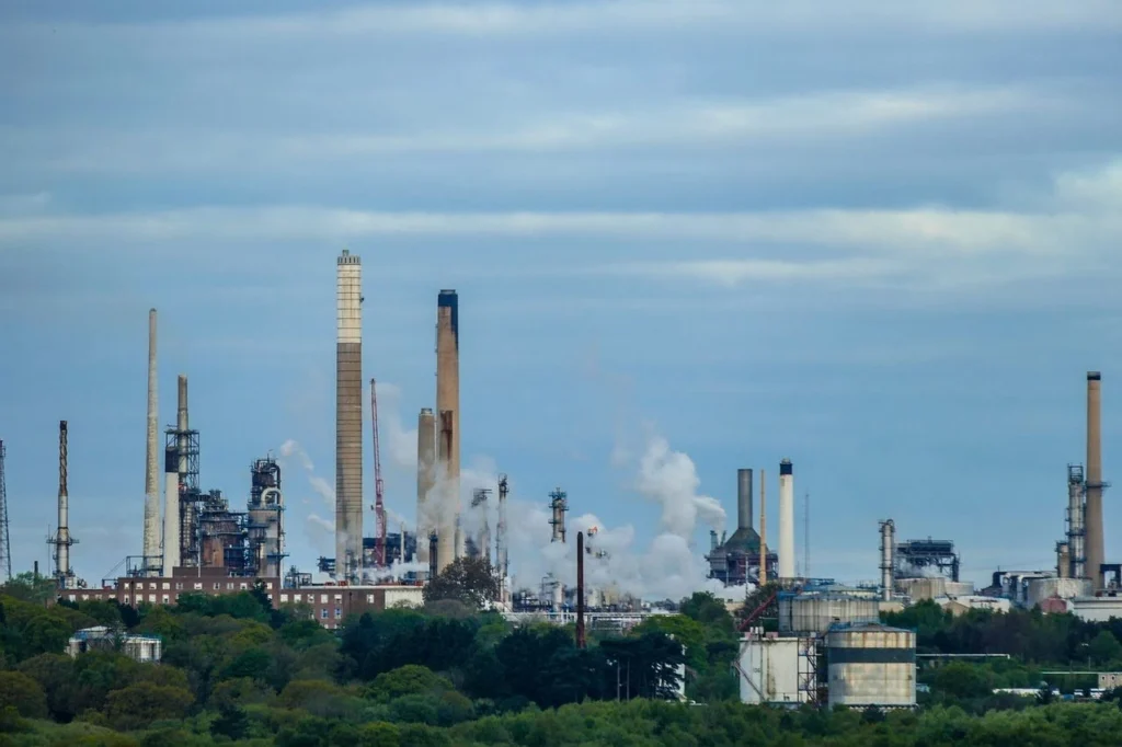 Fuel supply chain refinery with industrial processing facilities producing and distributing fuel across commercial networks