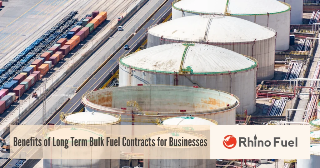 Industrial fuel storage facility with large cylindrical tanks and stacked shipping containers; overlay text reads 'Benefits of Long Term Bulk Fuel Contracts for Businesses'.